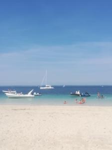 a group of people on a beach with boats in the water at Les Bruyeres in Concarneau +7 photos