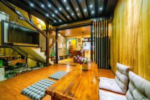 a living room with a wooden table and a tv at Lazy Cat in Luodong