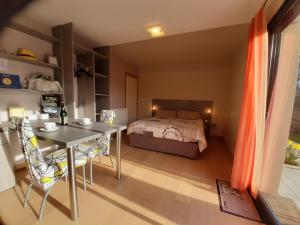 a bedroom with a bed and a table and chairs at Gîte des Douces'Eure in Cierrey