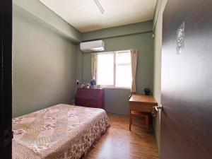Postel nebo postele na pokoji v ubytování 博愛泊旅讀心境