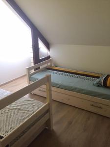 a bedroom with a bunk bed and a chair at La maison du bonheur proche plage composée de 2 appartement et d'une belle terrasse in Étaples