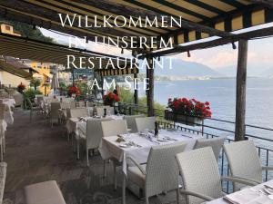 a restaurant with tables and chairs and a view of the ocean at Residenza Bettina BnB & Ferienwohnungen in Ronco sopra Ascona