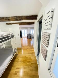 a room with bunk beds and a wooden floor at Bertoko Urdaibai III in Bermeo