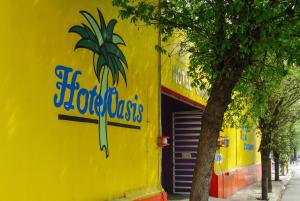 a yellow building with a sign on the side of it at Hotel Oasis in Monterrey +11 photos