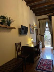 a living room filled with furniture and a window at Hotel Mangalemi in Berat
