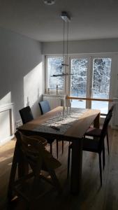 a dining room table and chairs in a room with snow at Forsthaus Wegenerskopf in Thale