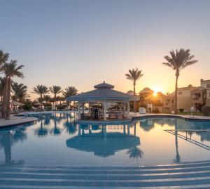 a pool with a gazebo and palm trees at SRNTY Sea Reef - Ex Serenity Alpha Beach in Hurghada