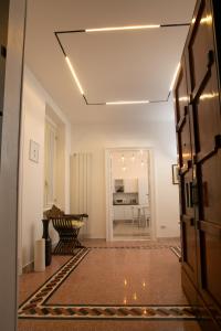 a hallway with a table and a dining room at Abate Luxury Interno 3 in Bari