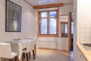 a kitchen and dining room with a table and chairs at Cozy 1 Br Apt and Free parking by the Railway station in Oulu