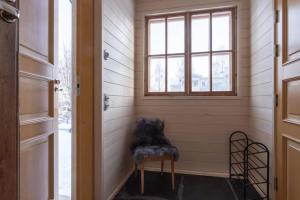 a room with a chair and a window at Cozy 1 Br Apt and Free parking by the Railway station in Oulu