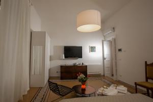 a living room with a couch and a tv at Abate Luxury Interno 3 in Bari