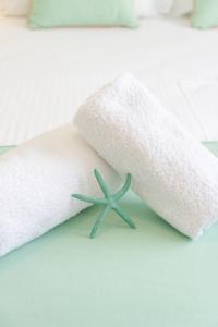 a white towel with a starfish sticking out of it at Hestia Harmony Living in Limenaria
