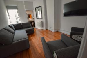 a living room with a couch and a tv at Old Compton Street in London