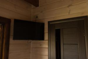 a flat screen tv hanging on a wall at Family Wood in Svityazʼ