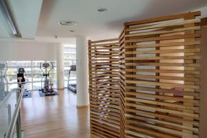 a large wooden wall in a room with a gym at Hotel Margarita Real in Pampatar