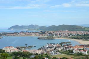a view of a city and a body of water at Apartamentos La Reserva Isla "Playa de la Cava" in Isla
