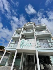 a white building with a blue sky in the background at Hotel del Mar in Valeria del Mar