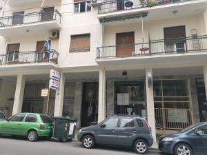 a group of cars parked in front of a building at Cozy Studio next to Acropolis & Plaka in Athens