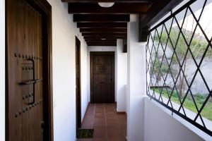 a hallway with a door and a window at tuGuest Carataunas Apartment II Alpujarra in Carataunas +27 photos