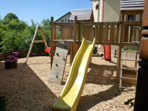 a playground with a slide in a yard at Gasthof Hotel Traube in Oberndorf