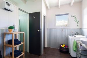 a bathroom with a black door and a sink at Number 10 Arrowtown Sleeps 12 in Arrowtown