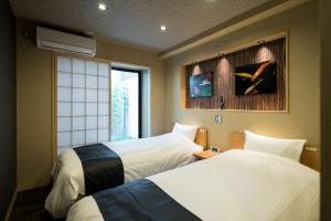 Postel nebo postele na pokoji v ubytování Shiki Suites - Kyoto Umekoji + 22 fotografií