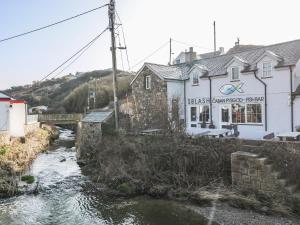 a bridge over a river next to a building at Tan Bryn 2 in Aberdaron