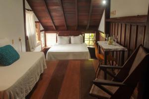 מיטה או מיטות בחדר ב-Casa de Hospedagem Paraty