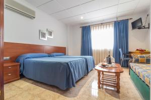 Postel nebo postele na pokoji v ubytování Hotel Reig