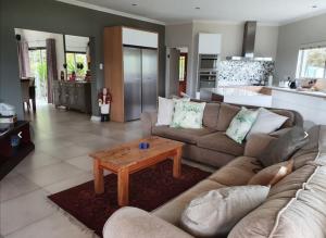a living room with a couch and a coffee table at Lagoon View Villa in Knysna