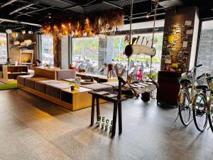 a store with a couch and bikes in a room at Meci Hotel in Hualien City