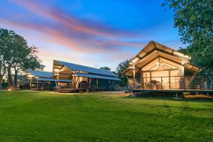 a large building with a grass field in front of it at Kimberleyland Waterfront Holiday Park in Kununurra
