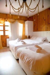 a group of four beds in a room at SÜMELA HOLİDAY HOTEL in Macka