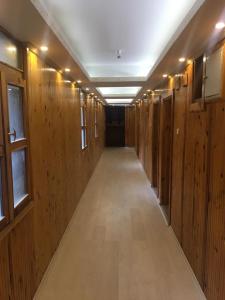 a long hallway with wood paneled walls and a long aisle at SÜMELA HOLİDAY HOTEL in Macka