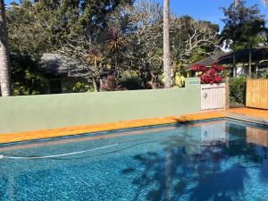 a swimming pool in front of a fence at Banyan Tree B&B Retreat in Makawao