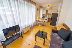 a living room with a couch and a table at Svaneti Apartment's - Cozy Mountain Apartments in Mestia in Mestia +24 photos