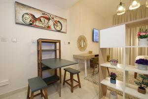 a room with a table and a motorcycle on the wall at SHH - Elegant Studio Apartment in Arena Apartments in Dubai