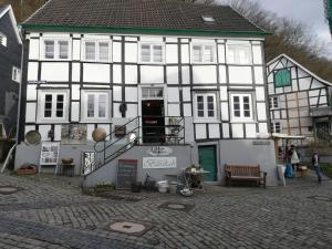 a large white and black building on a street at Ferienwohnung Am Schloßberg in Solingen