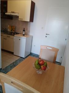 a bowl of fruit on a table in a kitchen at APARTMAN SUNCE in Baška Voda