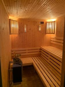 a wooden sauna with a bench in the middle at Apartments Vila Matija in Zlatibor