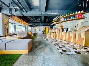a room with couches and tables in a store at Meci Hotel in Hualien City