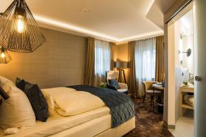 a hotel room with a bed and a desk at Landgasthof Kleiner in Sundern +27 photos