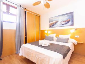 a bedroom with a large bed in a room at Slipper friendly Holiday Home in Playa del Ingles +30 photos