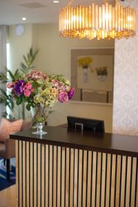 a vase of flowers on a counter in a room at Hogarths in Solihull