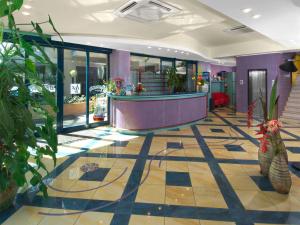 a lobby with a reception desk and plants at Hotel Diana in Bellaria-Igea Marina