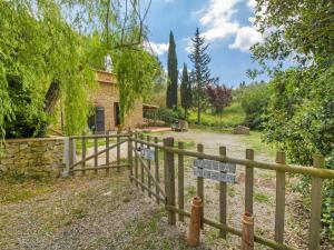 a wooden fence in front of a house at Holiday Home Villa Sofia by Interhome in Volterra