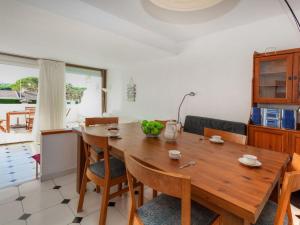a dining room with a wooden table and chairs at Apartment Ducado Golf B II by Interhome in Pals