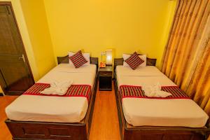Una cama o camas en una habitación de Hotel Bougainvillea