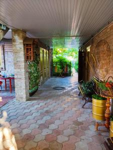 a patio with a stone floor and a building at Yuzhny Briz Guest House in Yeysk