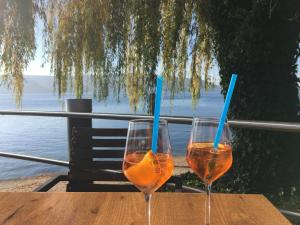 two wine glasses sitting on a wooden table at FeWo Michaela Köst in Konstanz